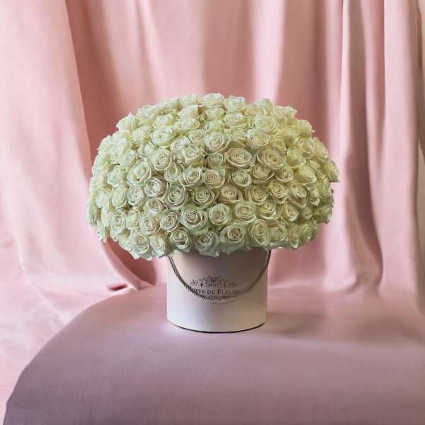 Large bouquet of white roses in a white hatbox