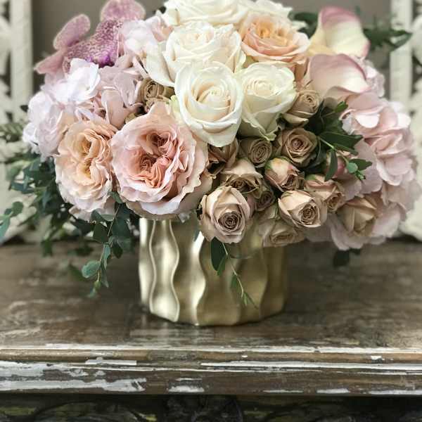 Blush and white rose bouquet in a gold vase