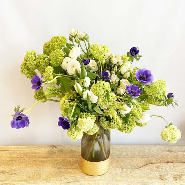 Bouquet of white and purple flowers in a glass vase