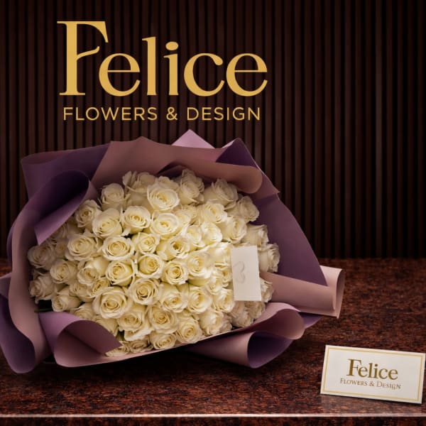 Large bouquet of cream roses wrapped in purple paper