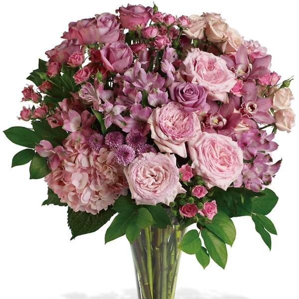 Pink mixed flower bouquet in a clear glass vase