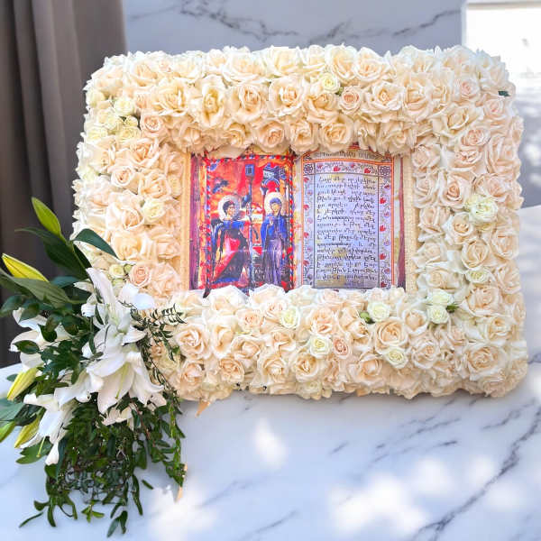 Cream rose floral frame with a central religious image and white lilies