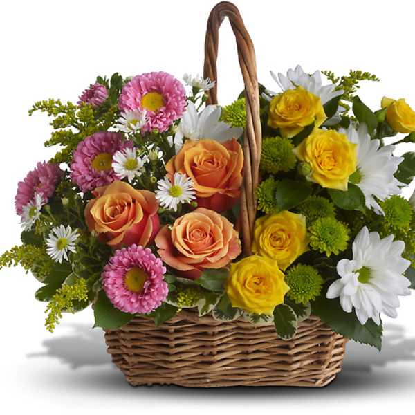 Basket arrangement of roses, daisies, and mums in pink, yellow, orange, and white