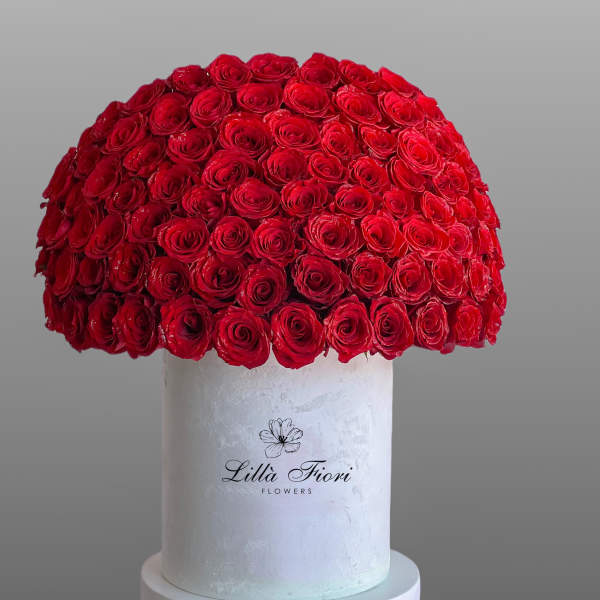 Large dome of red roses on a white pedestal box