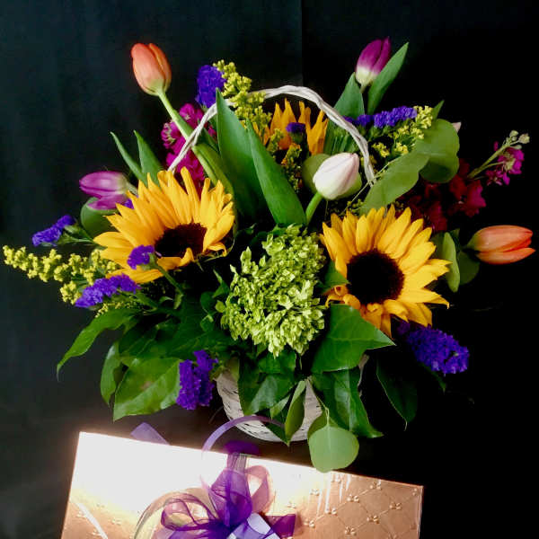 Basket of sunflowers and tulips with purple filler flowers