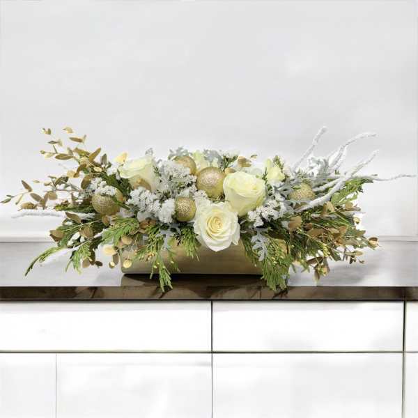 Low floral centerpiece with white roses and gold ornaments