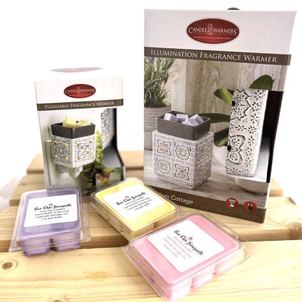 Fragrance warmer boxes with pastel wax melts on a wooden surface