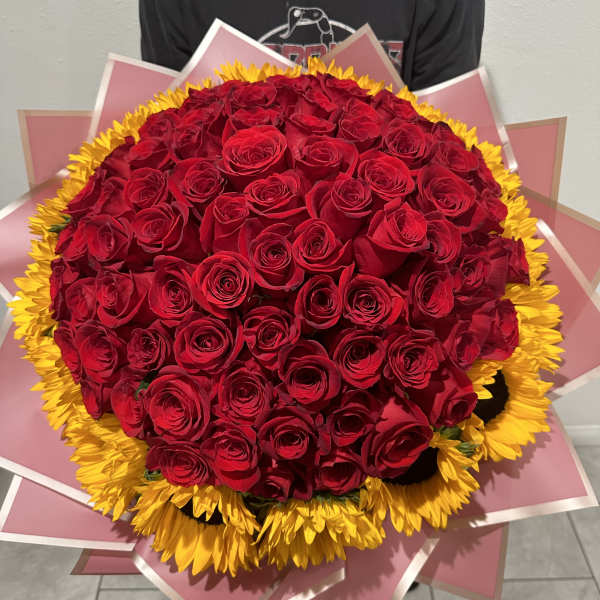 Large bouquet of red roses with a yellow sunflower border