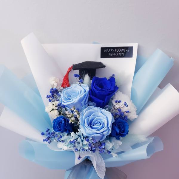 Blue rose bouquet with a graduation cap topper and light blue wrapping