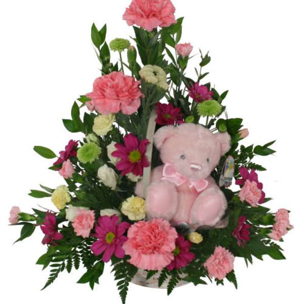 Pink and magenta flower arrangement with a pink teddy bear