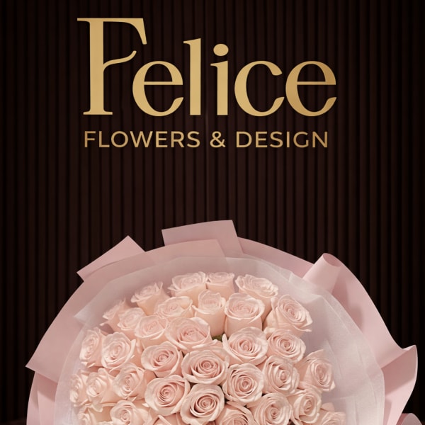 Bouquet of pale pink roses wrapped in pink paper