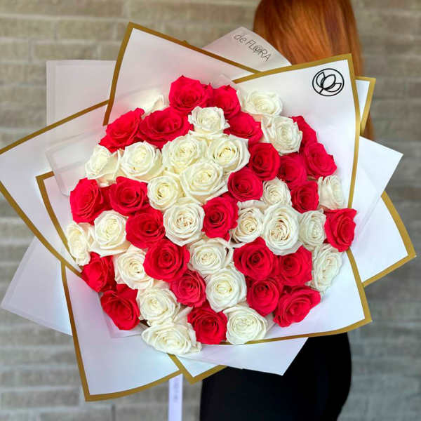 Large bouquet of red and white roses wrapped in white paper
