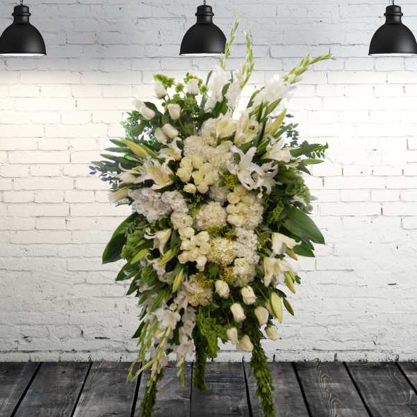 Large white floral standing spray with lilies and roses
