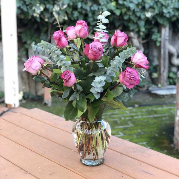 Pink roses arranged in a clear glass vase