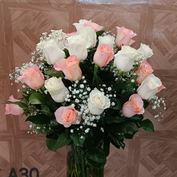 Bouquet of pink and white roses in a clear glass vase