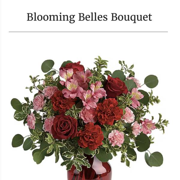 Red and pink bouquet in a red glass vase