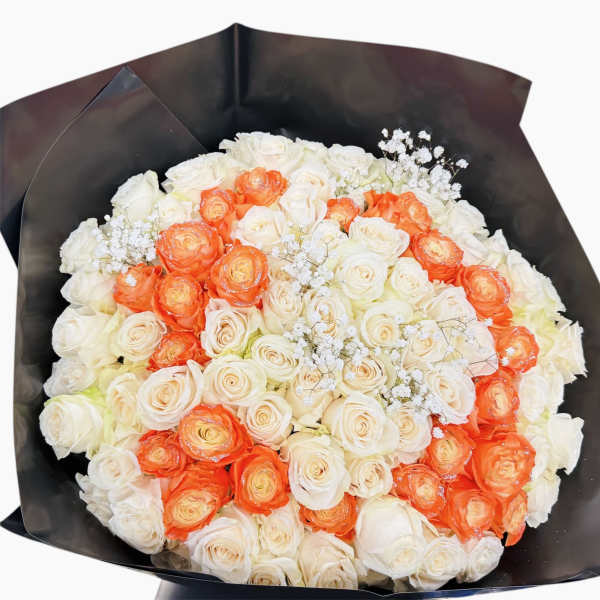 Bouquet of white and orange roses wrapped in black paper