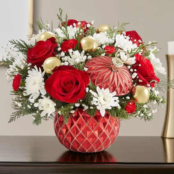 Red roses and white daisies arranged in a red ornament vase