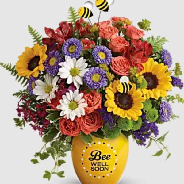 Mixed bouquet in a yellow vase with a Bee Well Soon message