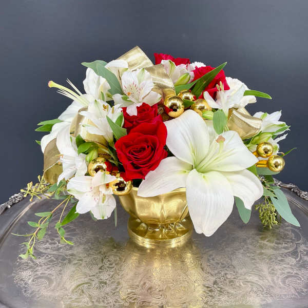 Bouquet of red roses and white lilies in a gold vase