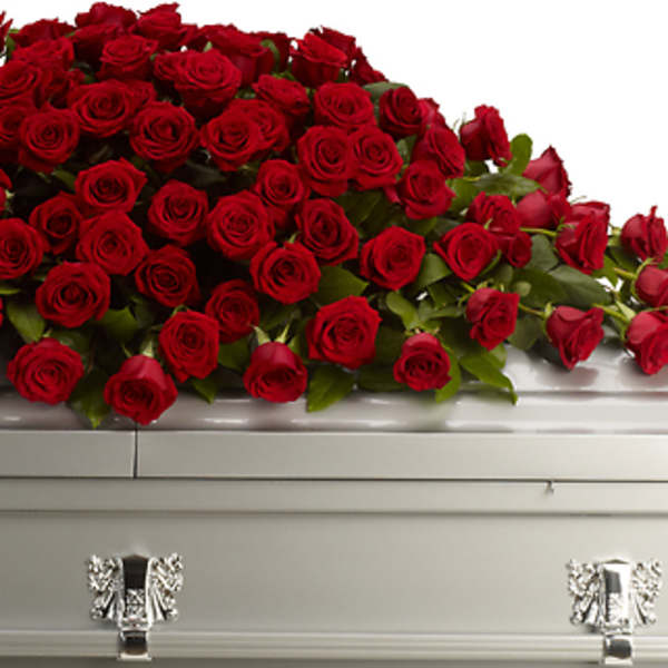 Red rose casket spray on a silver casket