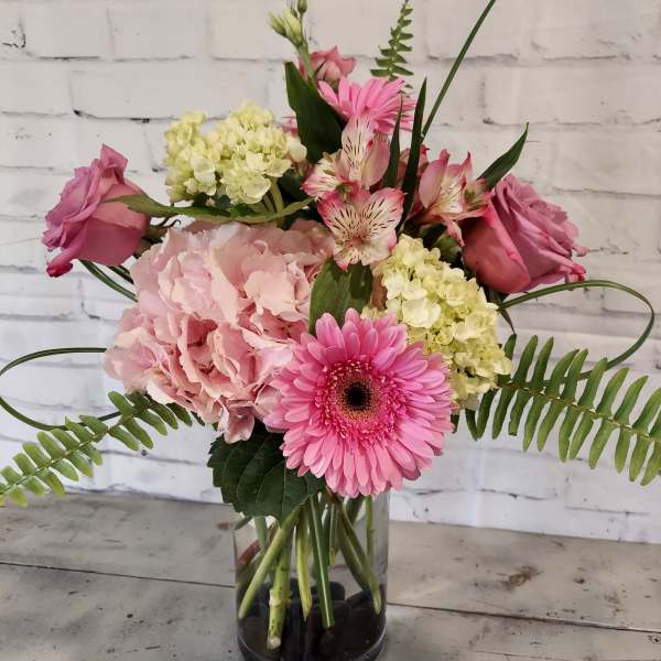 Pink and cream mixed bouquet in a clear glass vase