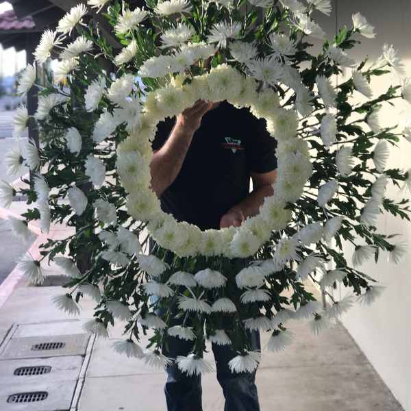 Large white floral wreath with a circular center opening