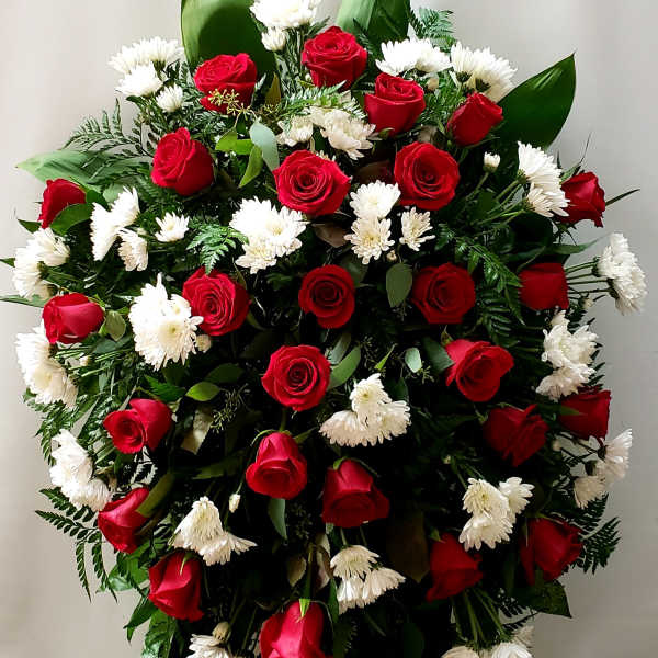 Large standing arrangement of red roses and white daisies