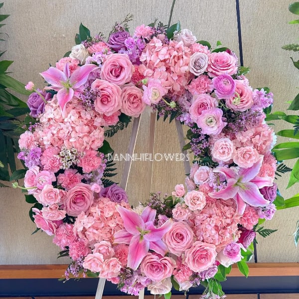 Pink and lavender floral wreath on a wooden easel