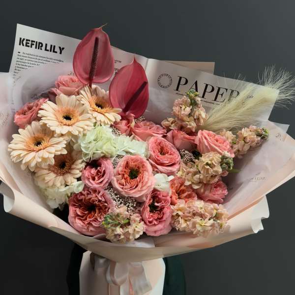 Pink and cream bouquet with gerbera daisies and anthuriums in paper wrap