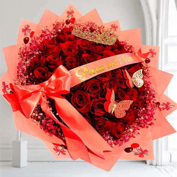 Large bouquet of red roses wrapped in pink paper with a ribbon and crown