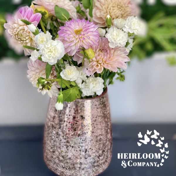Pink and white flowers arranged in a metallic vase