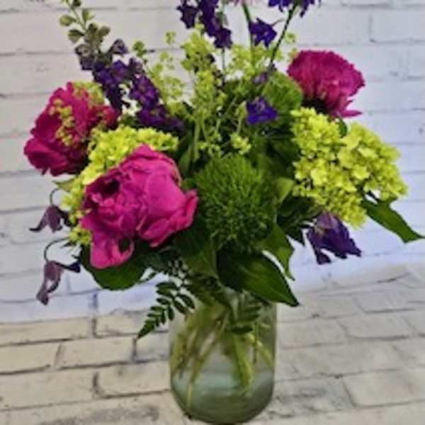 Pink and purple mixed bouquet in a glass vase