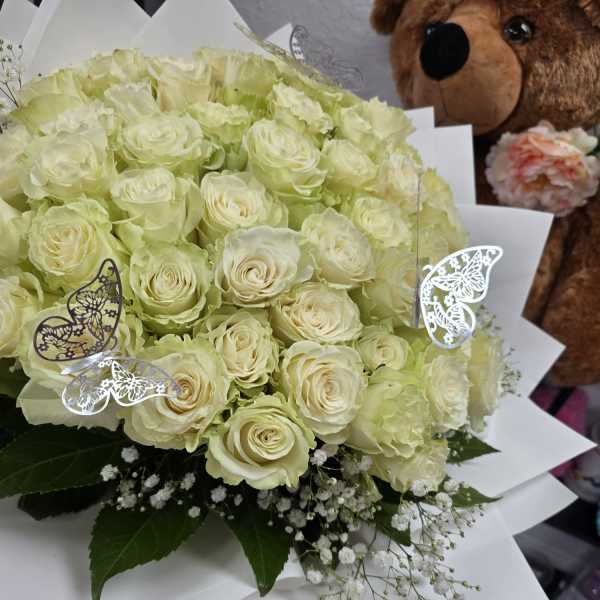 Bouquet of pale cream roses with white baby's breath and butterfly picks