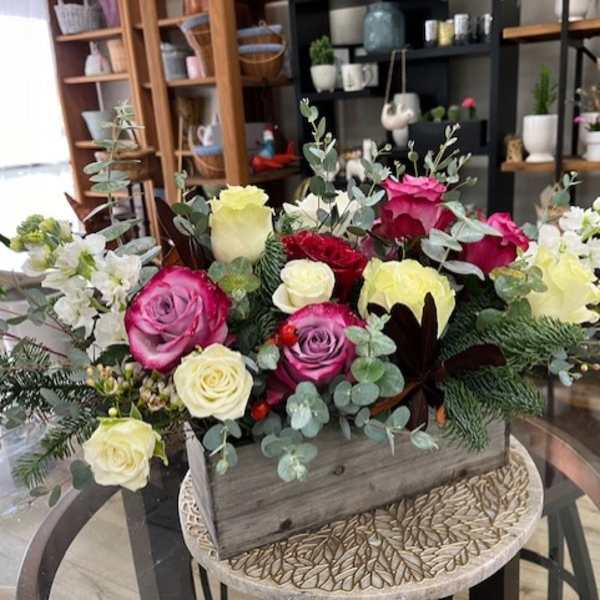 Mixed roses in a wooden box with eucalyptus and white filler flowers