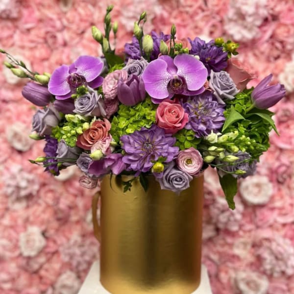 Purple and pink bouquet in a gold vase