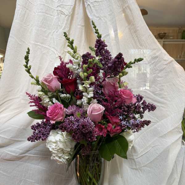Pink and purple mixed bouquet in a clear glass vase