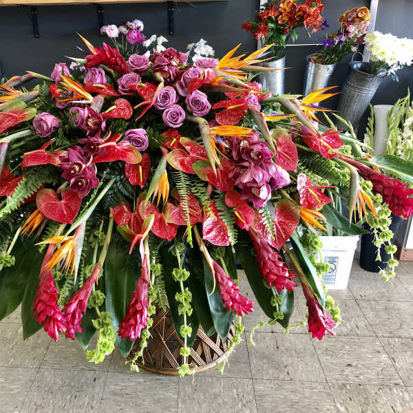 Large tropical floral arrangement in a woven basket