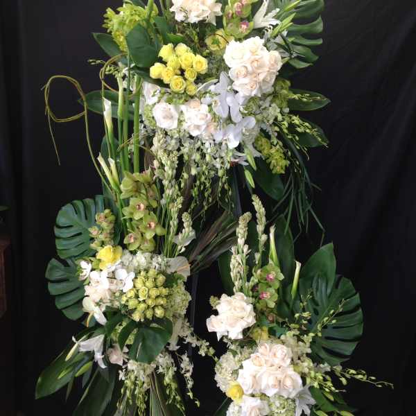 Tall floral standing arrangement with white and pale yellow blooms