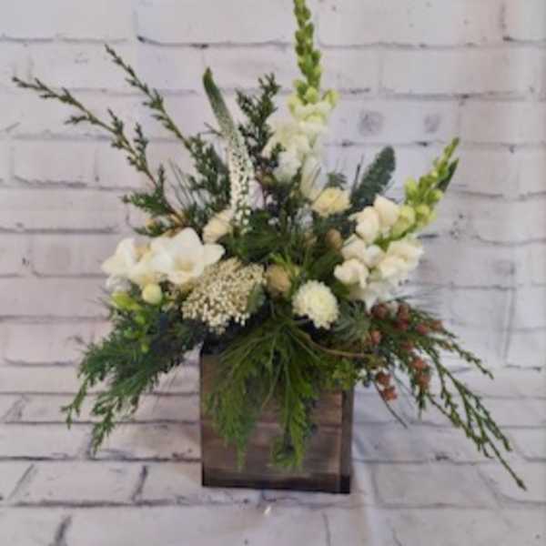 White floral arrangement in a square wooden container