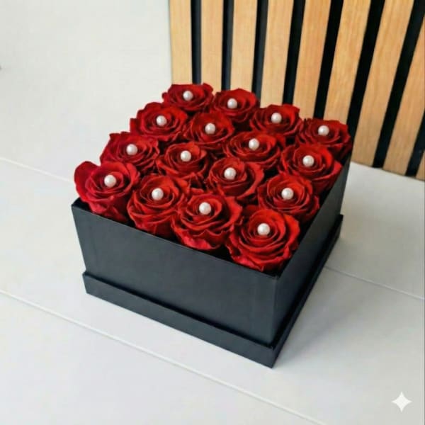 Box of red roses topped with pearl accents