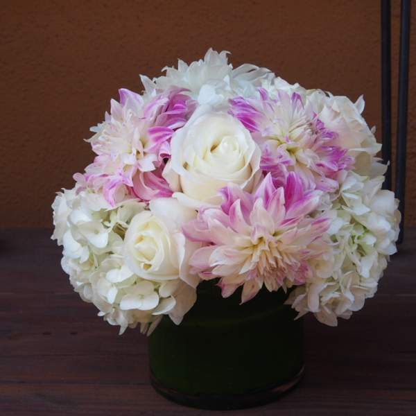 White and pink flower arrangement in a dark vase