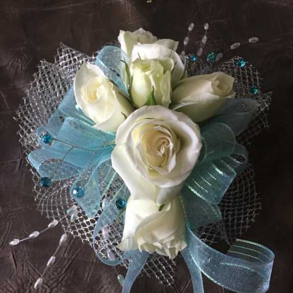 White rose bouquet with blue ribbon and silver mesh wrap