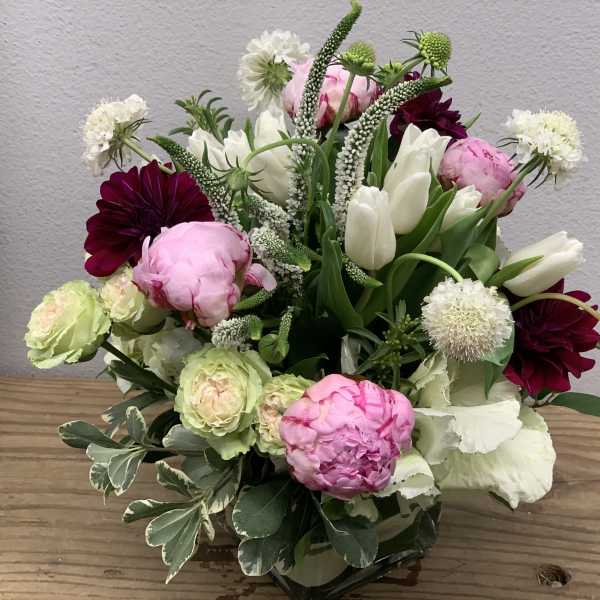 Mixed bouquet with pink peonies, white tulips, and dark burgundy blooms