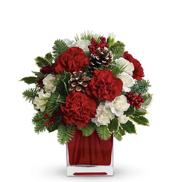 Red and white floral arrangement in a clear square vase