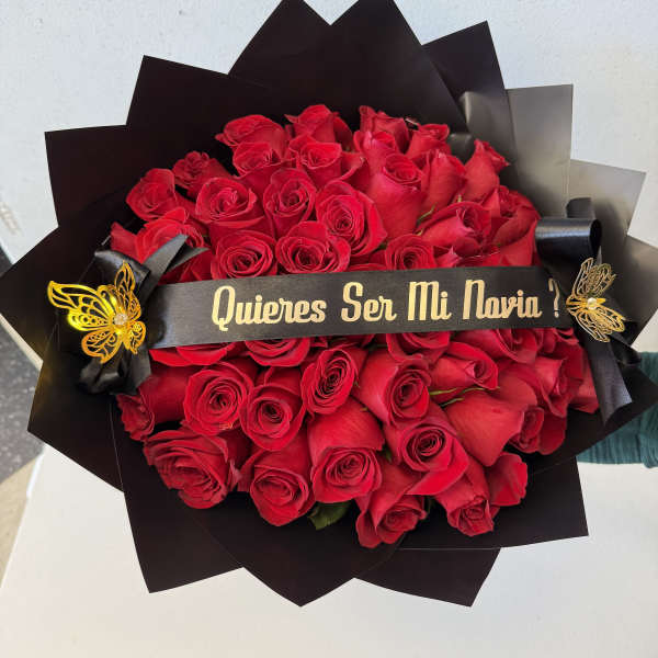 Bouquet of red roses wrapped in black paper with a ribbon