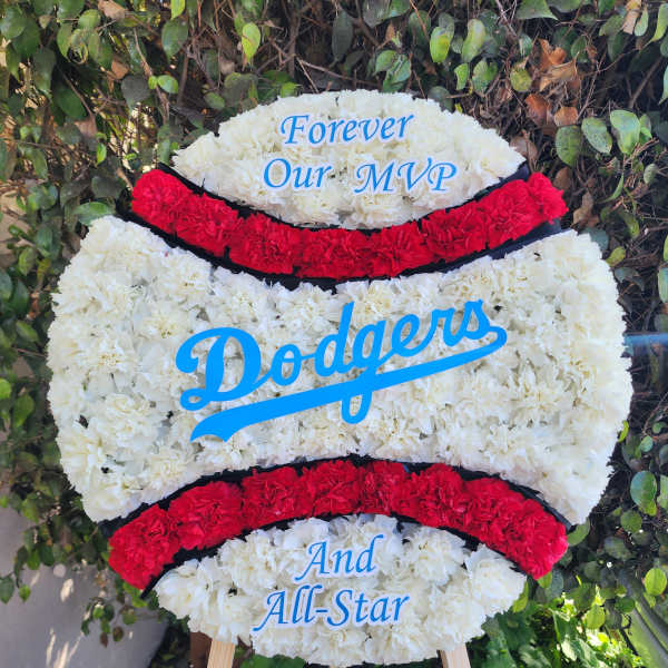 Dodgers-themed floral tribute on an easel with white and red flowers