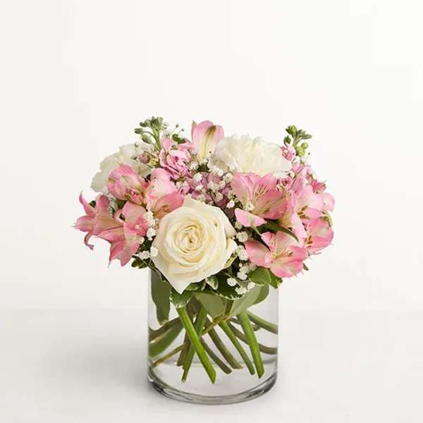 Pink and white bouquet in a clear glass vase