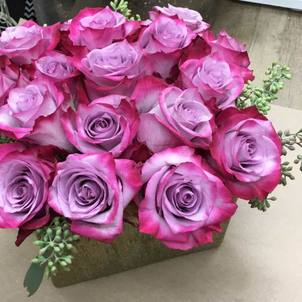 Bouquet of pink and lavender roses with succulent accents