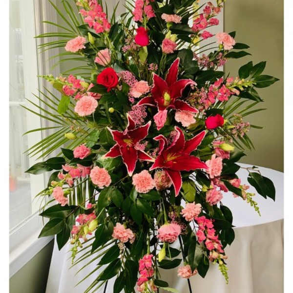Tall floral spray with red lilies and pink carnations